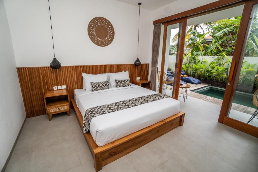 Postel nebo postele na pokoji v ubytování Kemari Ubud