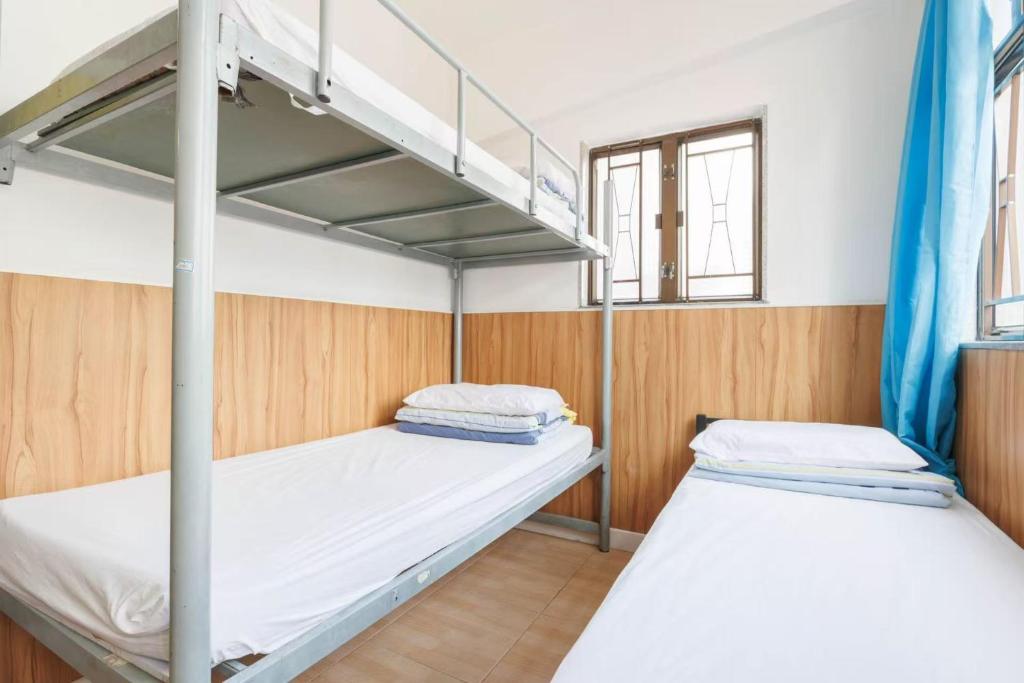 Voodi või voodid majutusasutuse Ah Shan Hostel toas