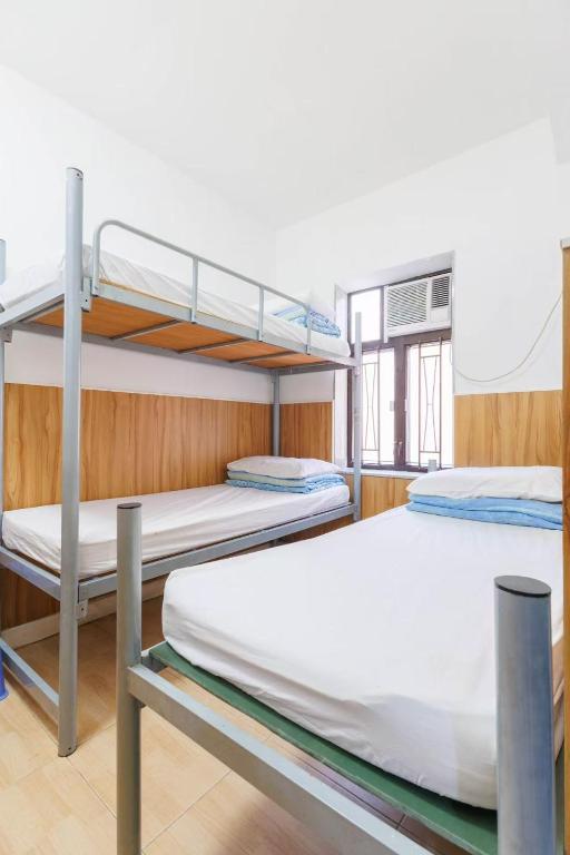 Voodi või voodid majutusasutuse Ah Shan Hostel toas