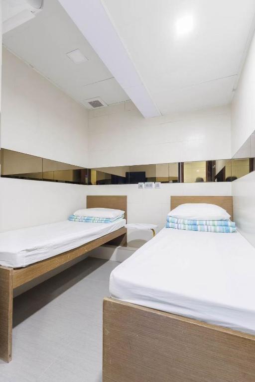 Voodi või voodid majutusasutuse Ah Shan Hostel toas