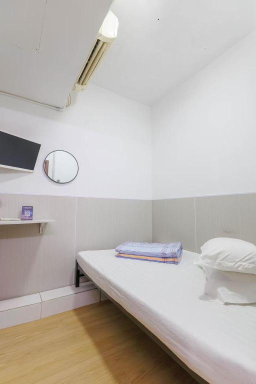 Voodi või voodid majutusasutuse Ah Shan Hostel toas