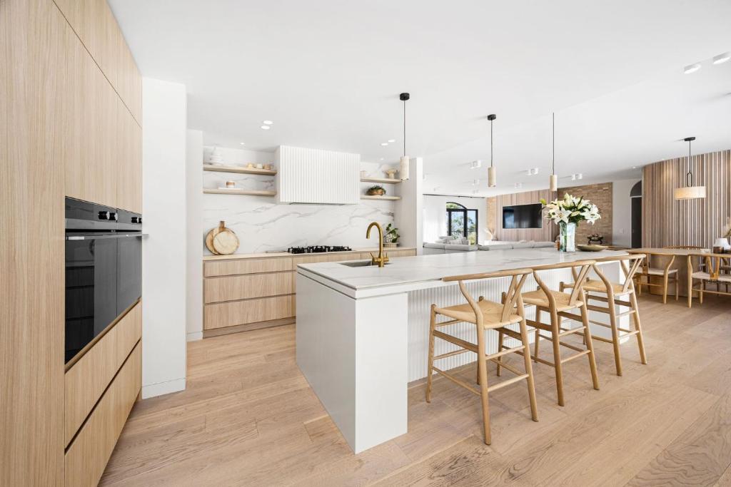 a kitchen with a white counter and a dining room at Querida Villa in Dromana