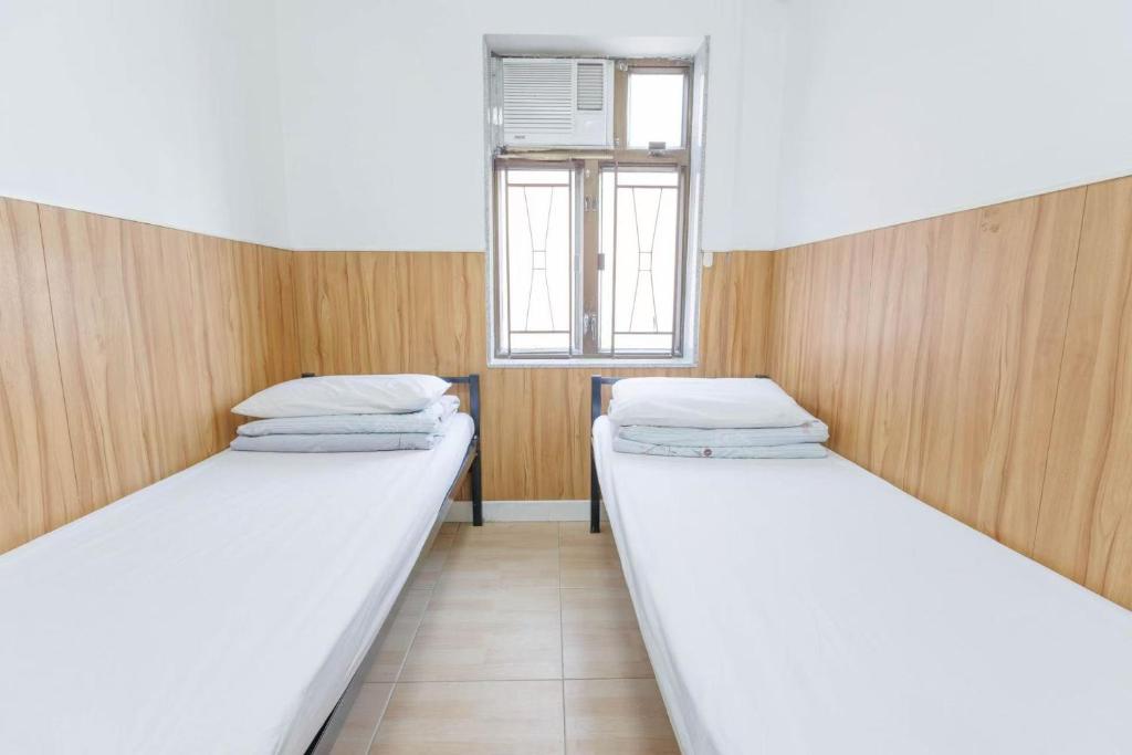 Voodi või voodid majutusasutuse Ah Shan Hostel toas