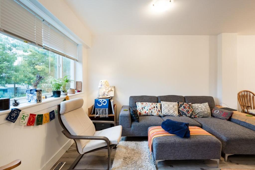 a living room with a couch and a chair at Beautiful Vancouver Cedar Cottage House in Vancouver