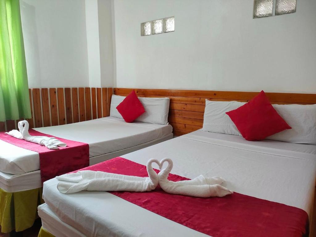 Postel nebo postele na pokoji v ubytování Axis Pension Hotel