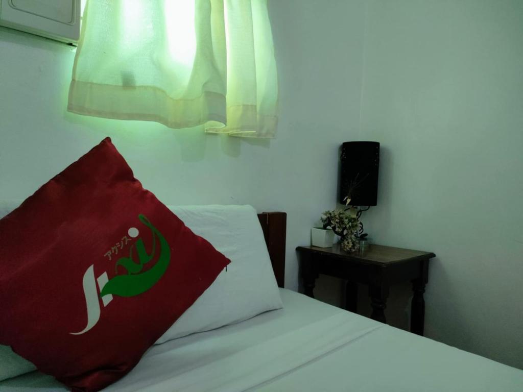 Postel nebo postele na pokoji v ubytování Axis Pension Hotel