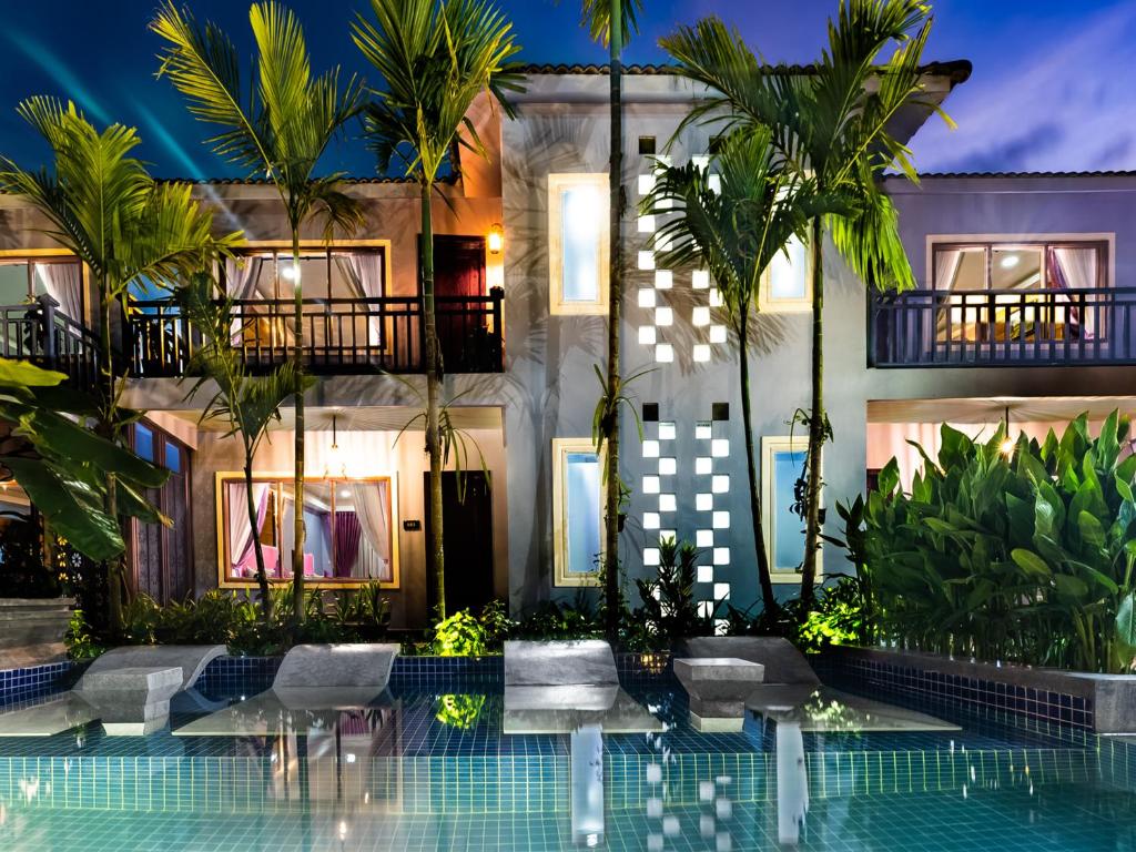a hotel with a swimming pool in front of a building at Cheata Residence in Siem Reap