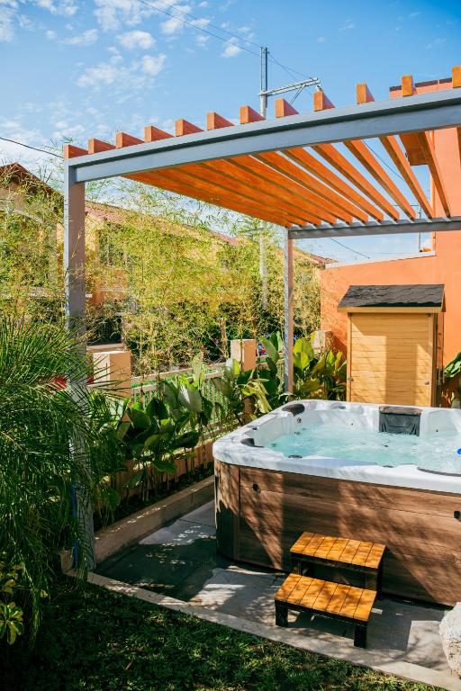 a hot tub in a garden with a pergola at Love, Lourdes Villa in Imus