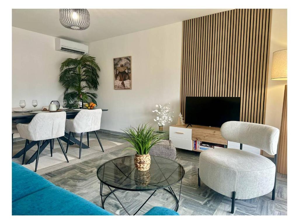 un salon avec une télévision, une table et des chaises dans l'établissement Appartement rénové à Juan les Pins avec parking - FR-1-252-198, à Antibes