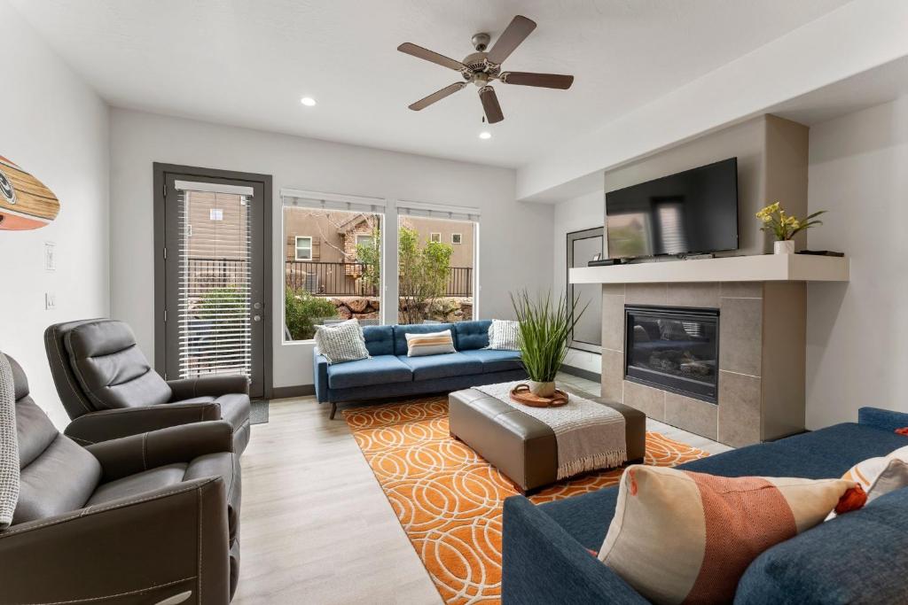 a living room with blue furniture and a fireplace at Best Day Ever townhouse in Washington