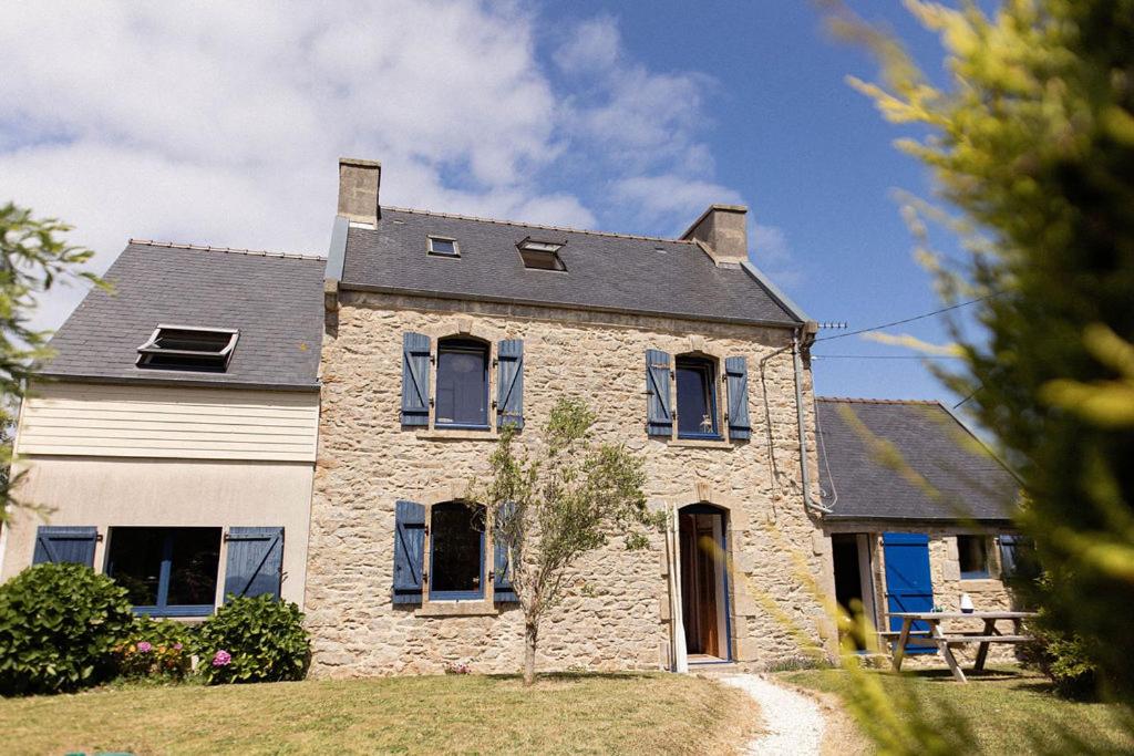 a large stone house with a black roof at Ty Glaz Lilia - La maison bleue in Plouguerneau