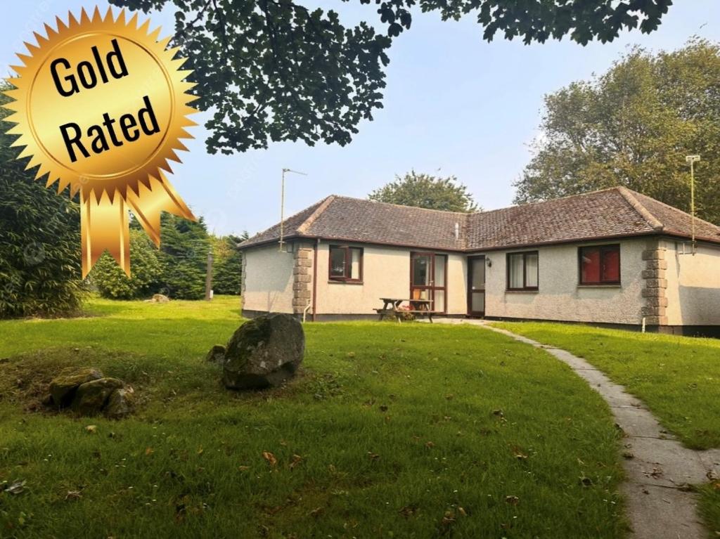 a house with a large sun sculpture in the yard at SeaBreeze Lodge, located between Penzance & St Ives - A sanctuary to relax & unwind with activities on the doorstep for all the family in Penzance