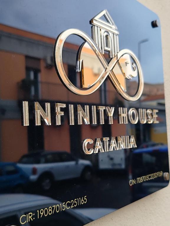 a book with a sign for an infinity house at Infinity House Catania in Catania