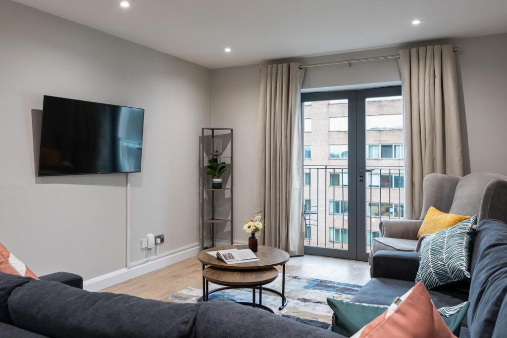 a living room with a couch and a tv at Stylish, Luxury, Parking Sleeps 6, 2-Bath, City Centre in Belfast