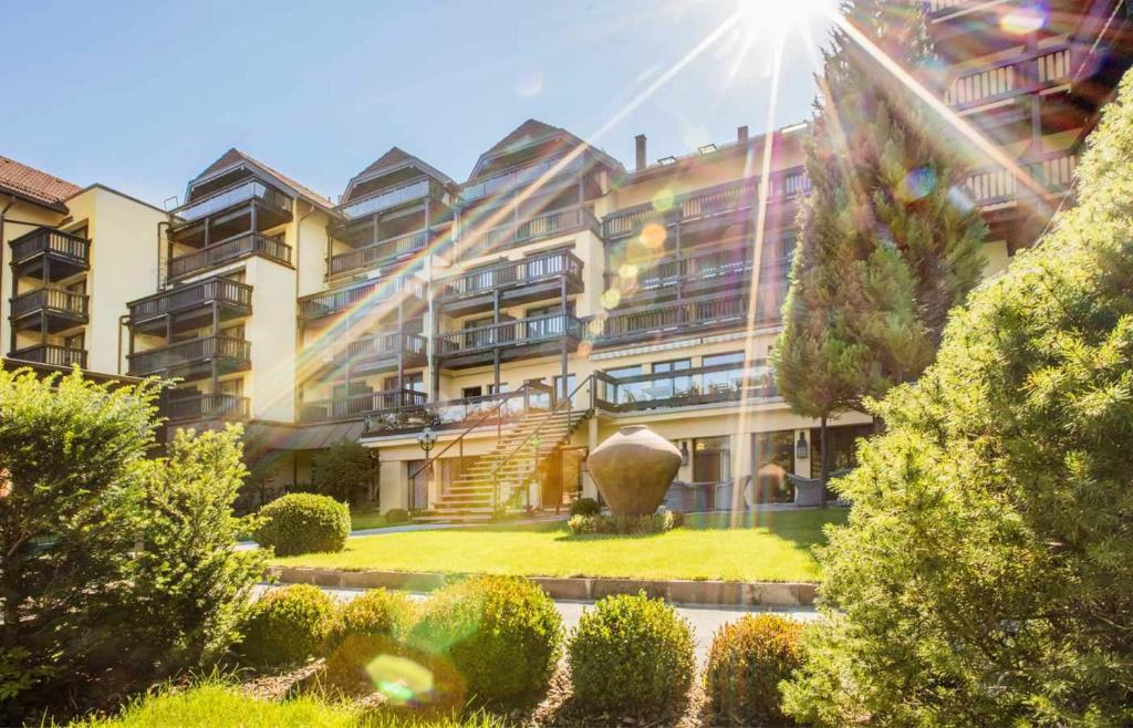 a large building with a garden in front of it at Parkhotel Luise Bad Herrenalb in Bad Herrenalb