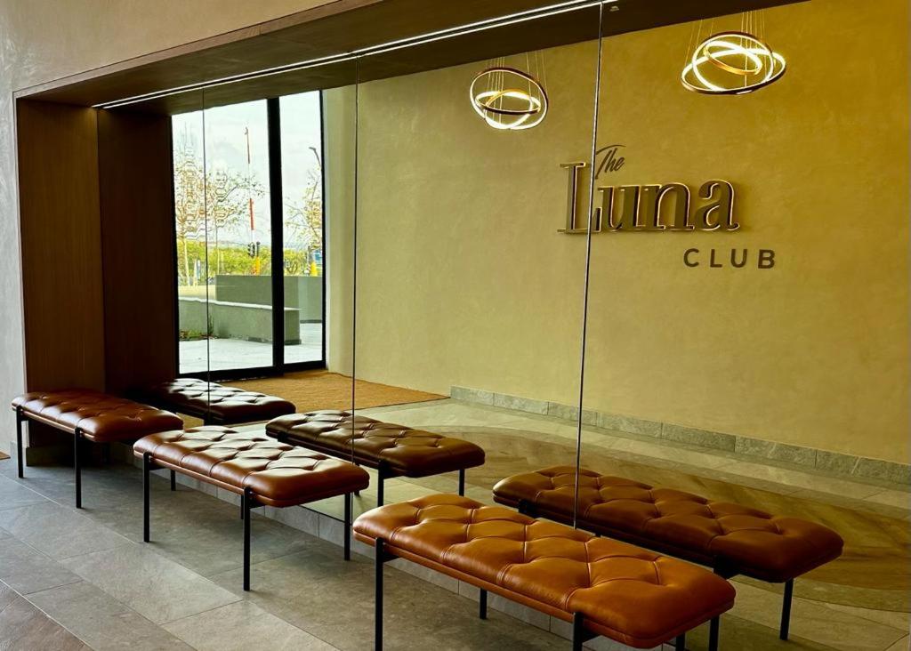 a waiting room with brown leather seats in a mall at Stunning 2 bedroom condo at Ellipse Midrand in Midrand