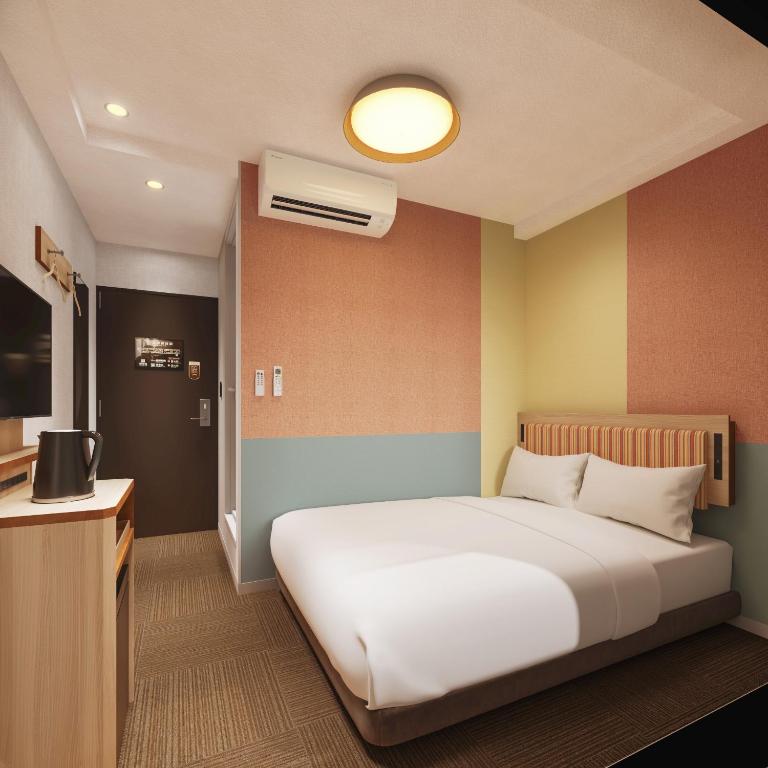 Postel nebo postele na pokoji v ubytování CVS Bay Hotel