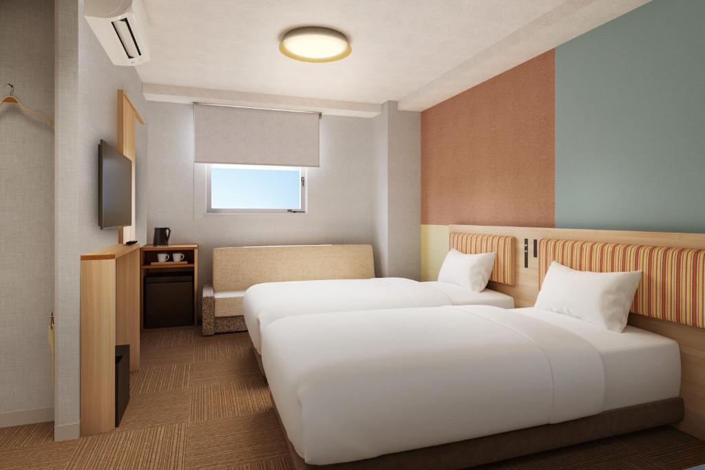 Postel nebo postele na pokoji v ubytování CVS Bay Hotel