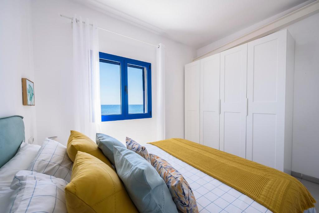 a bedroom with a bed and a window at Casa del Mar I in La Lajita