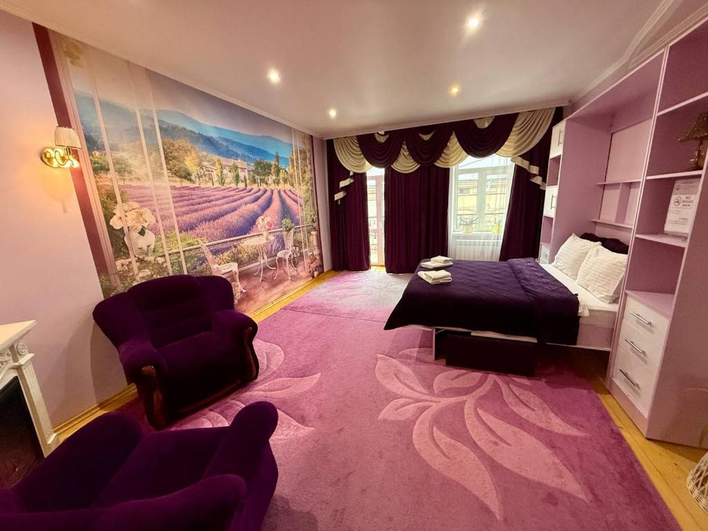 a living room with a bed and a couch at Apartments Provence in Chernivtsi