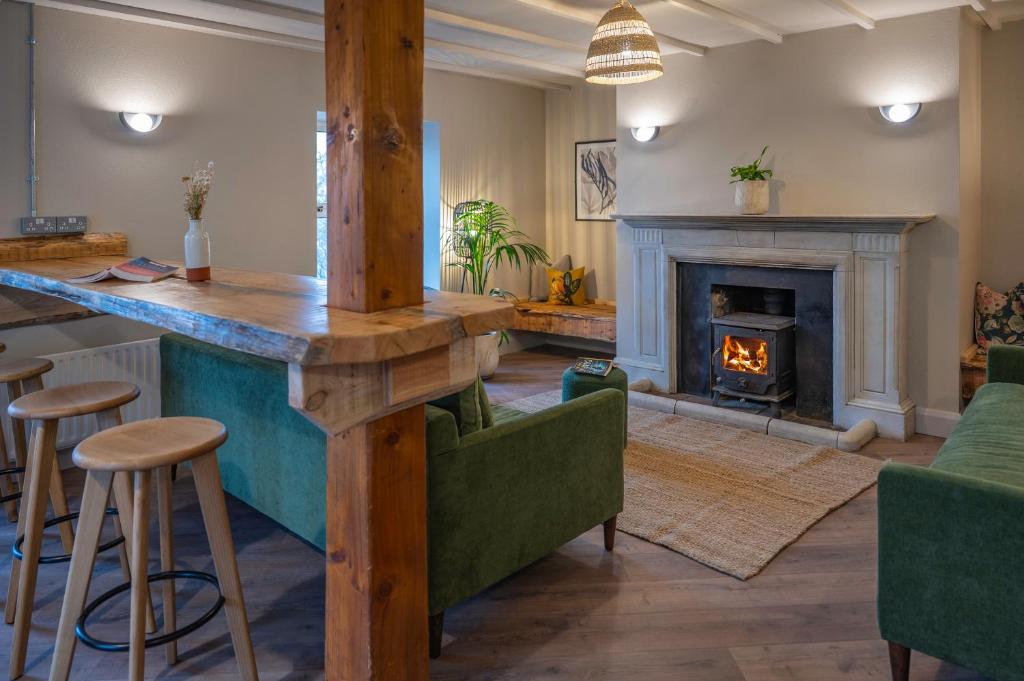 a living room with a bar and a fireplace at Otter Hostel Connemara in Leenaun