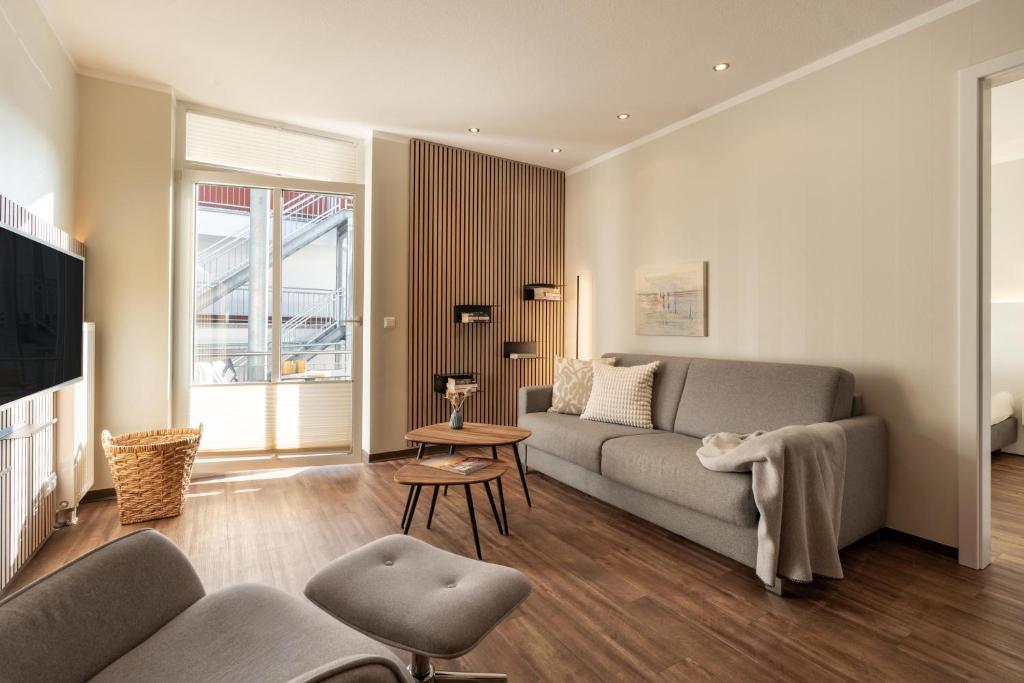 a living room with a couch and a table at Rodehuus Wohnung 7 in Borkum