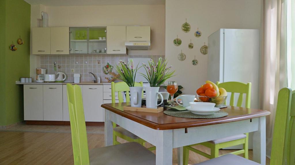 a kitchen with a table with a bowl of fruit on it at Апартамент Деа - Apartment Dea in Byala
