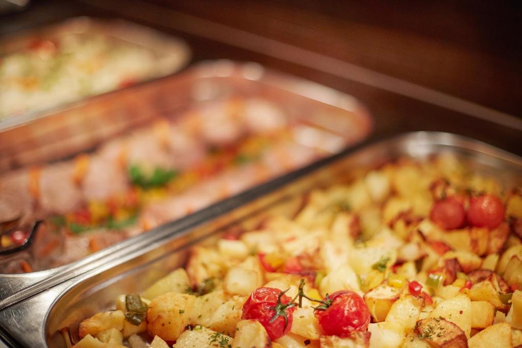 three metal trays filled with different types of food at Villas - Hotel & Resort Adria Ankaran in Ankaran