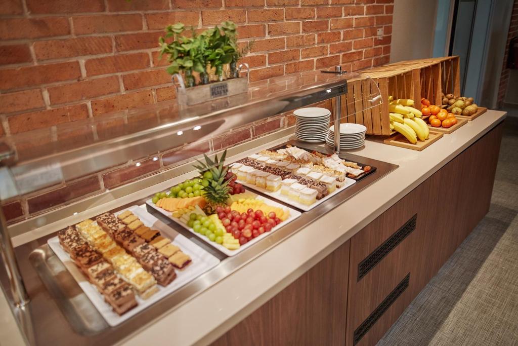 a buffet line with many different types of food at Olive Family Suites - Hotel & Resort Adria Ankaran in Ankaran