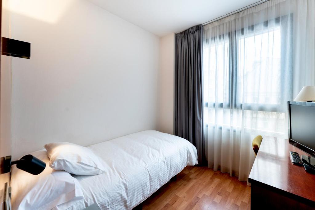 Postel nebo postele na pokoji v ubytování Hotel Doña Urraca