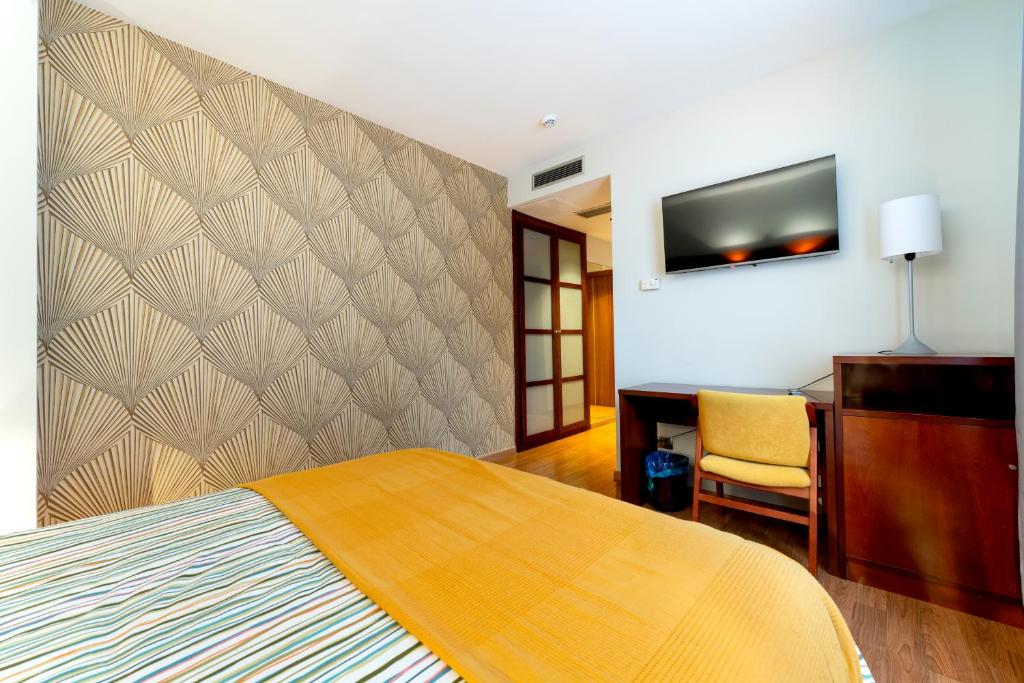 Postel nebo postele na pokoji v ubytování Hotel Doña Urraca
