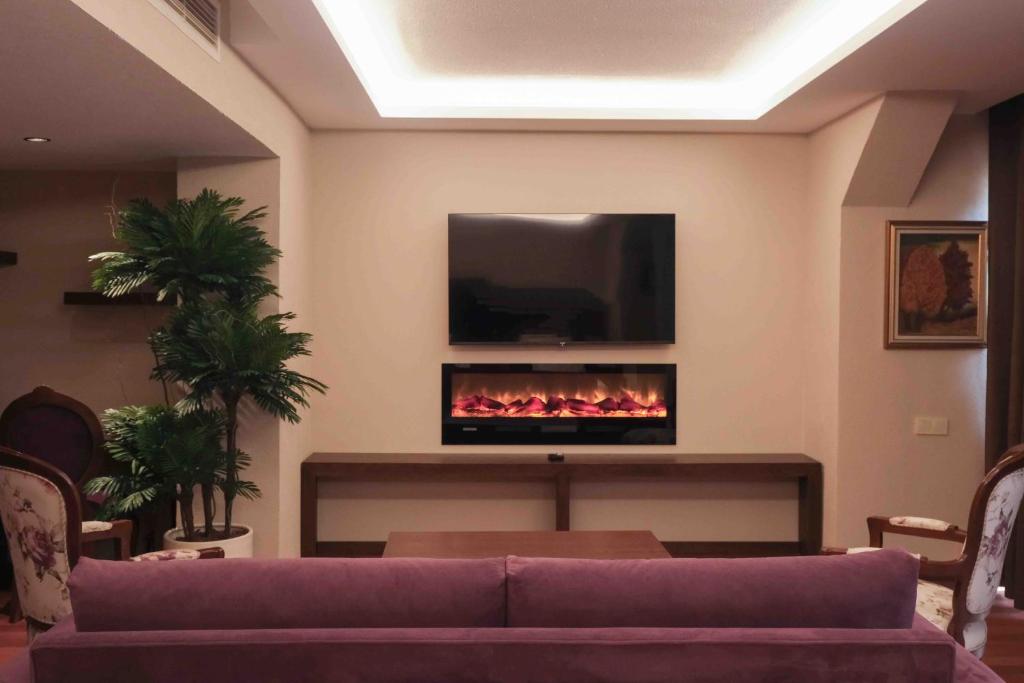 a living room with a couch and a fire place at Phellos Suites Boutique Hotel in Şile