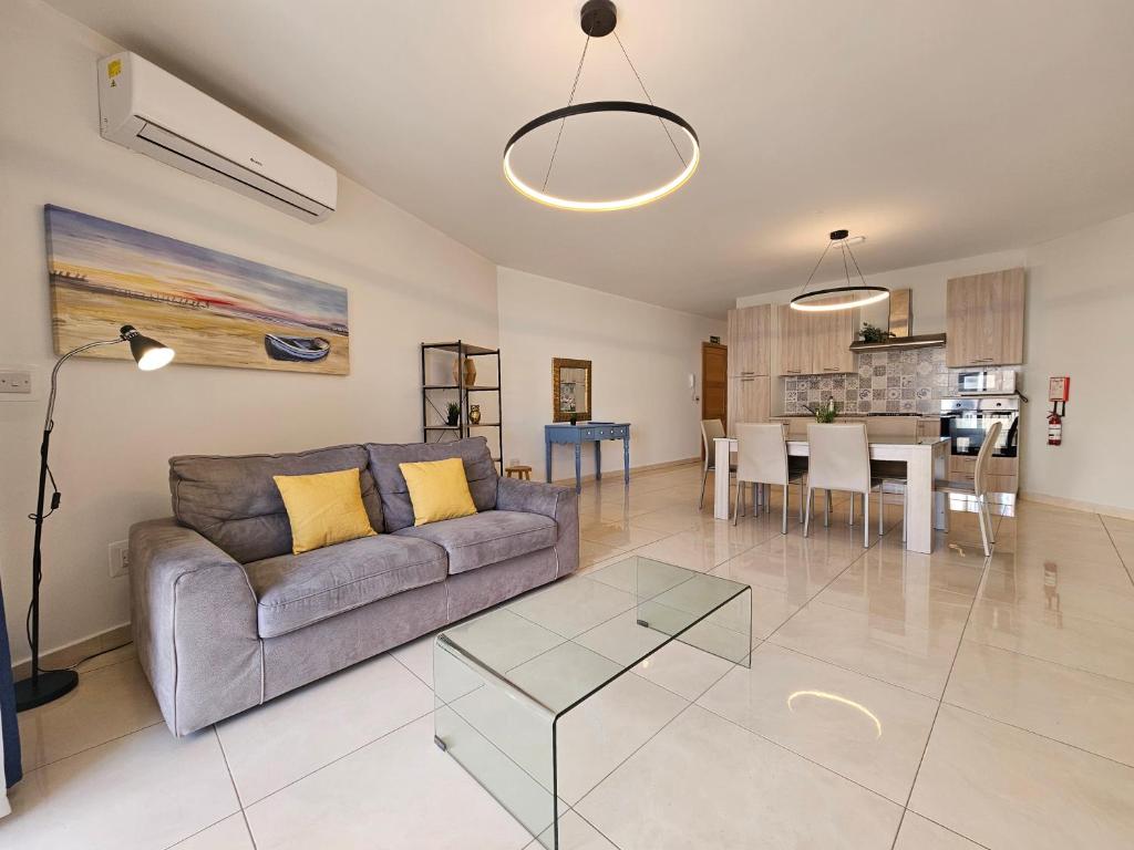 a living room with a couch and a table at SeaLine in St. Paul's Bay