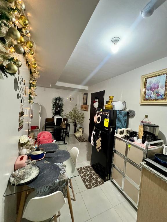 a kitchen with a table and a stove and a refrigerator at Affordable Condominium in Cebu in Cebu City