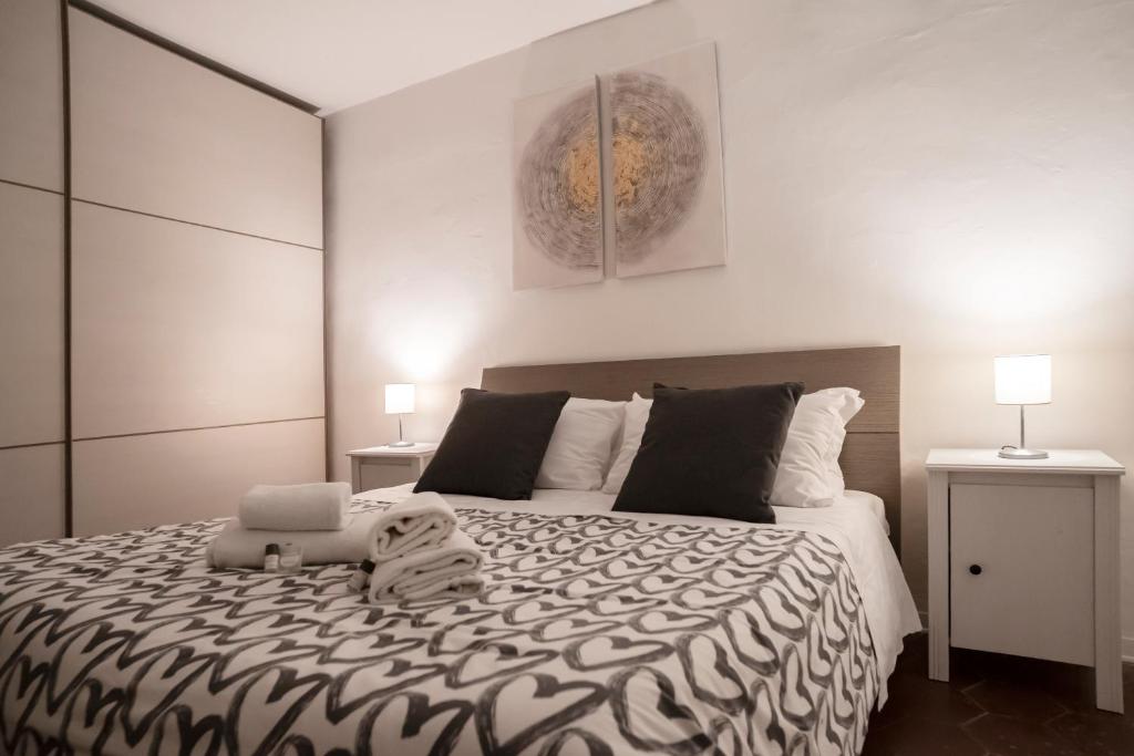 a bedroom with a large bed with a laptop on it at Pitti13 in Florence