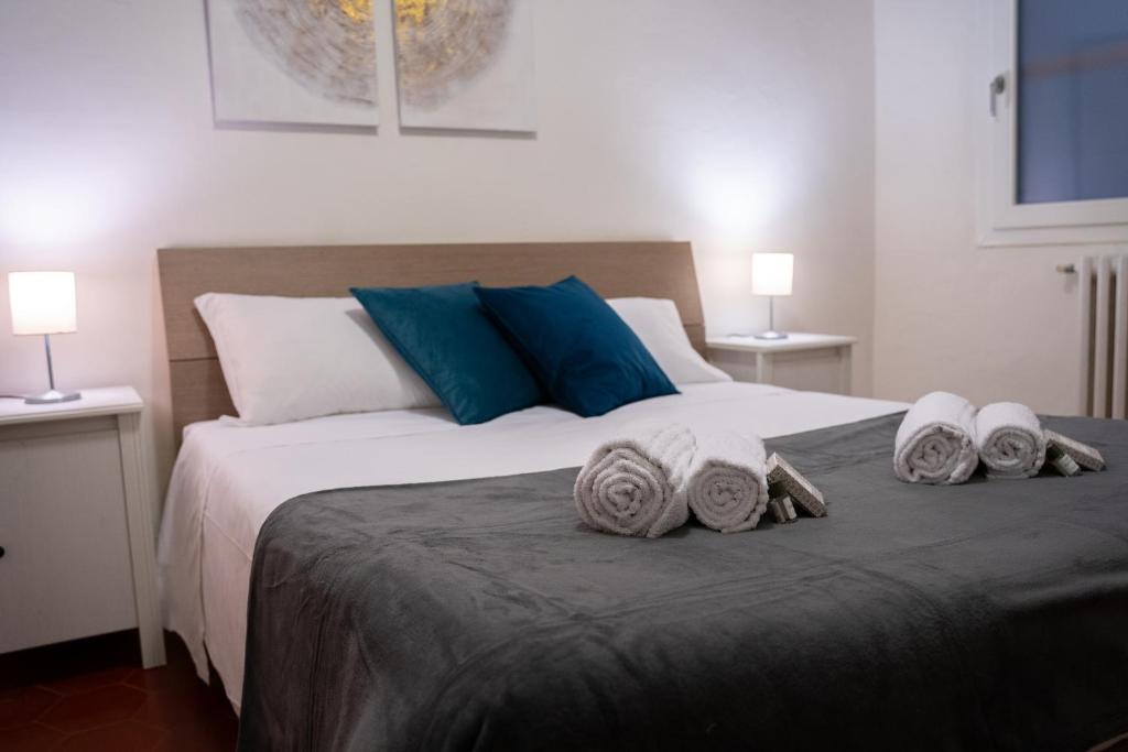 a bedroom with a large bed with towels on it at Pitti13 in Florence