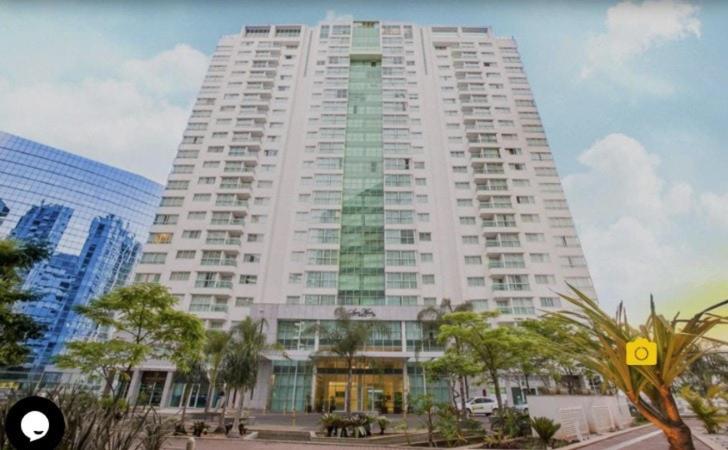 a large white building with trees in front of it at Saint Moritz Hotel em Brasília 91641 in Brasilia