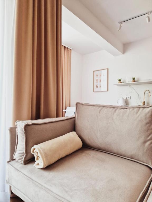 a couch with a pillow on it in a room at Apartament Gniezno Bulwary 7a in Gniezno