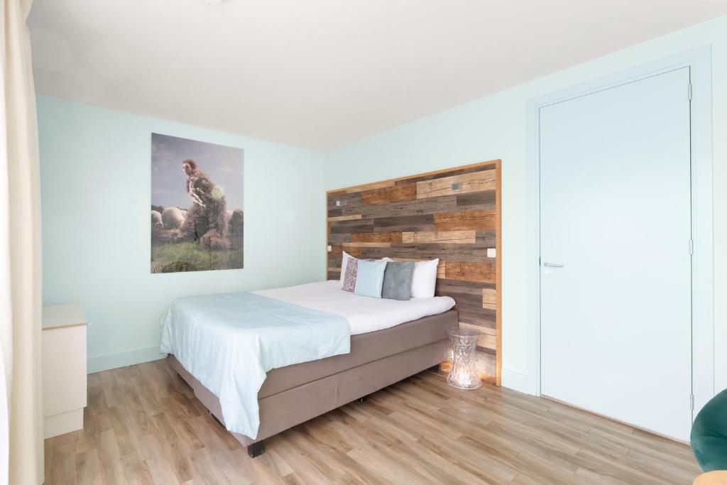 Postel nebo postele na pokoji v ubytování Strandhotel Zoutelande