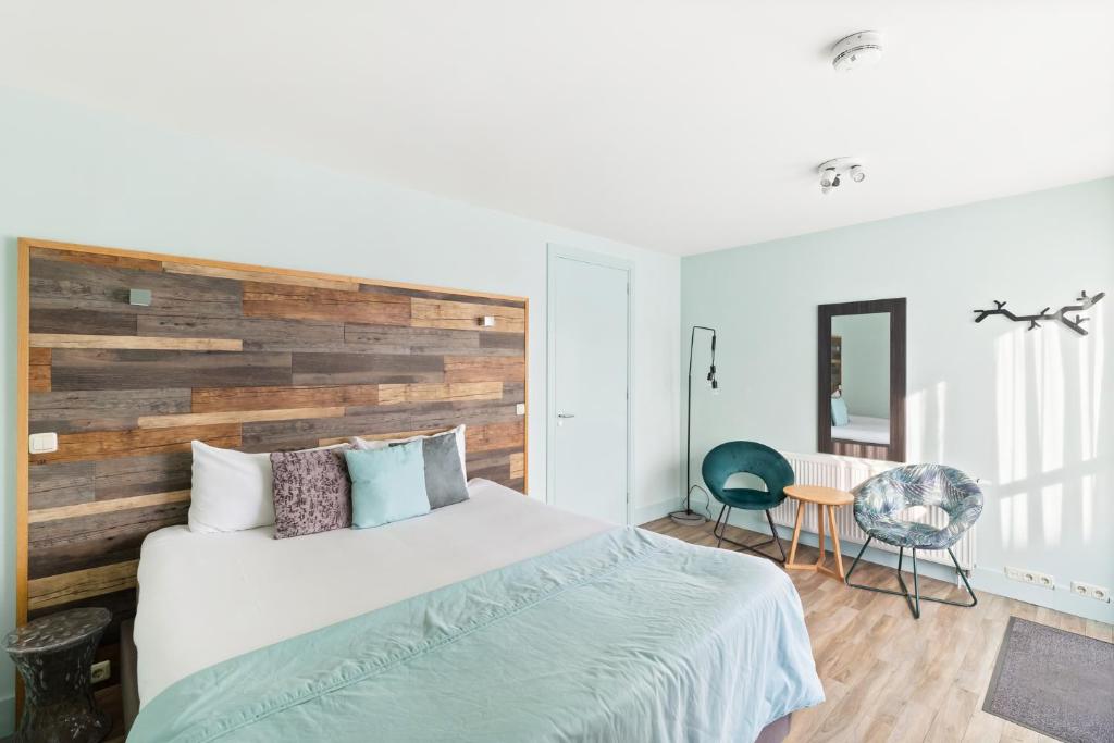 Postel nebo postele na pokoji v ubytování Strandhotel Zoutelande