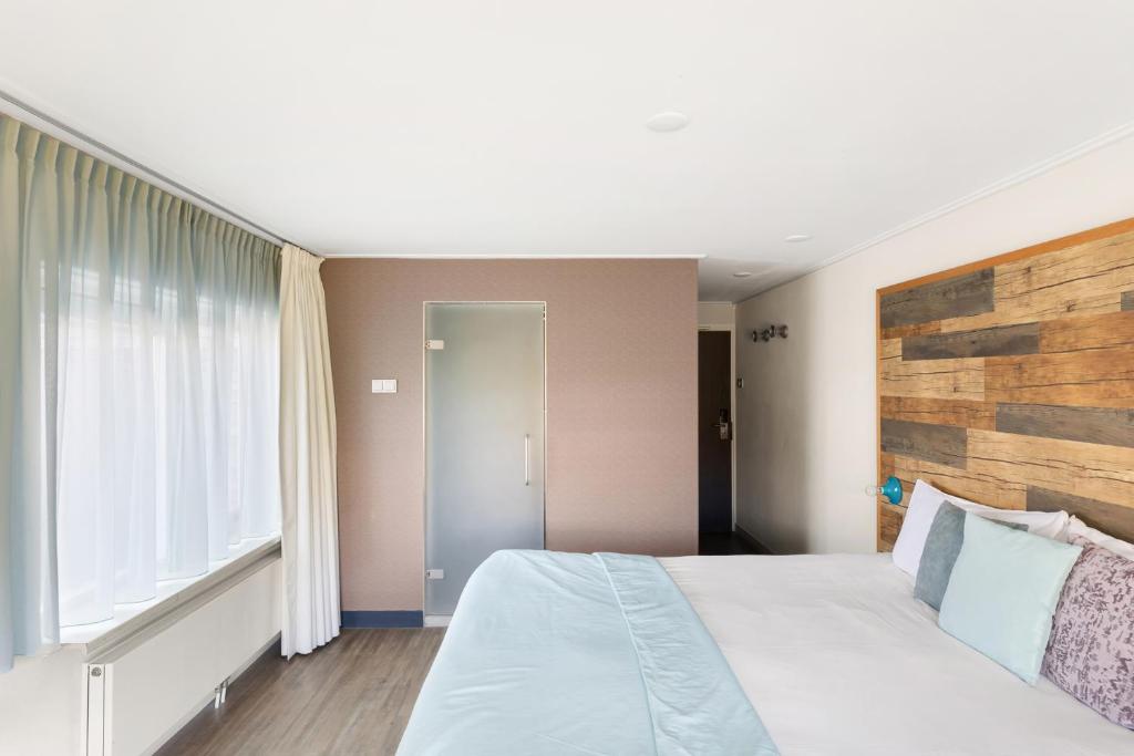 Postel nebo postele na pokoji v ubytování Strandhotel Zoutelande