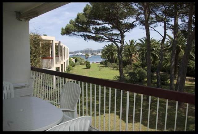 un balcon avec une table et des chaises et une vue sur l'océan dans l'établissement T2 dans une résidence proche de la mer et du centre du village, à Porquerolles