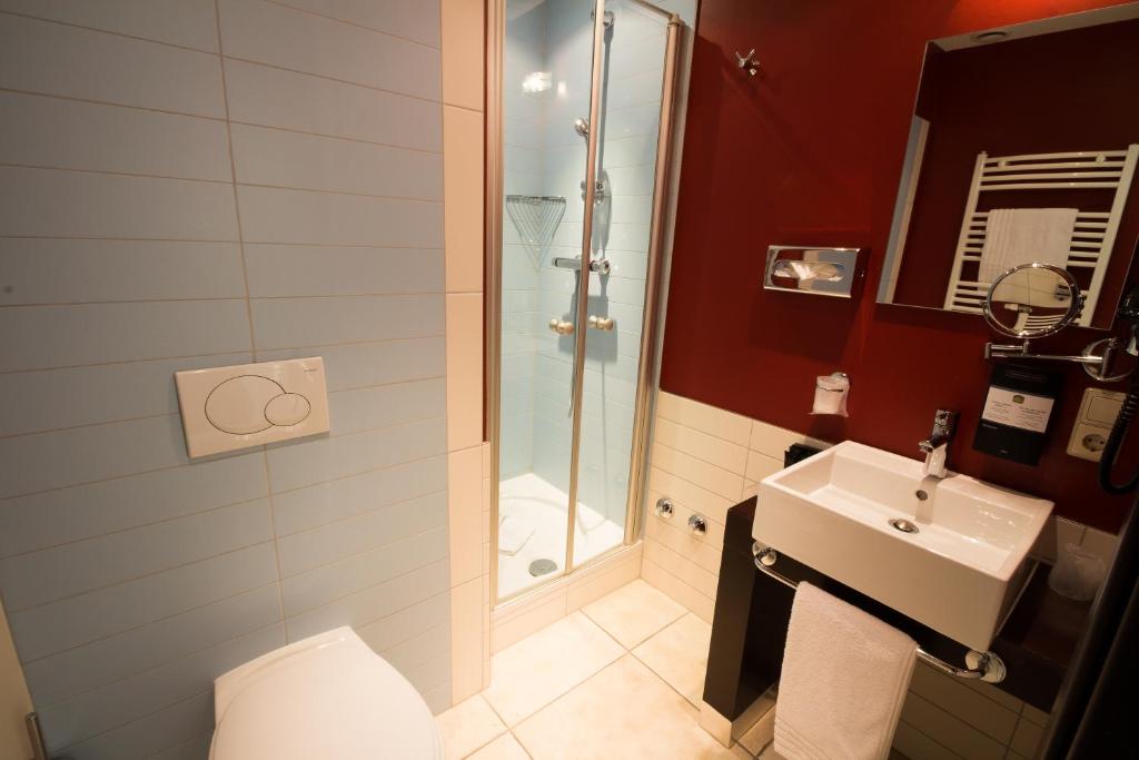 a bathroom with a shower and a sink at Best Western Plus Grand Hotel Victor Hugo in Luxembourg