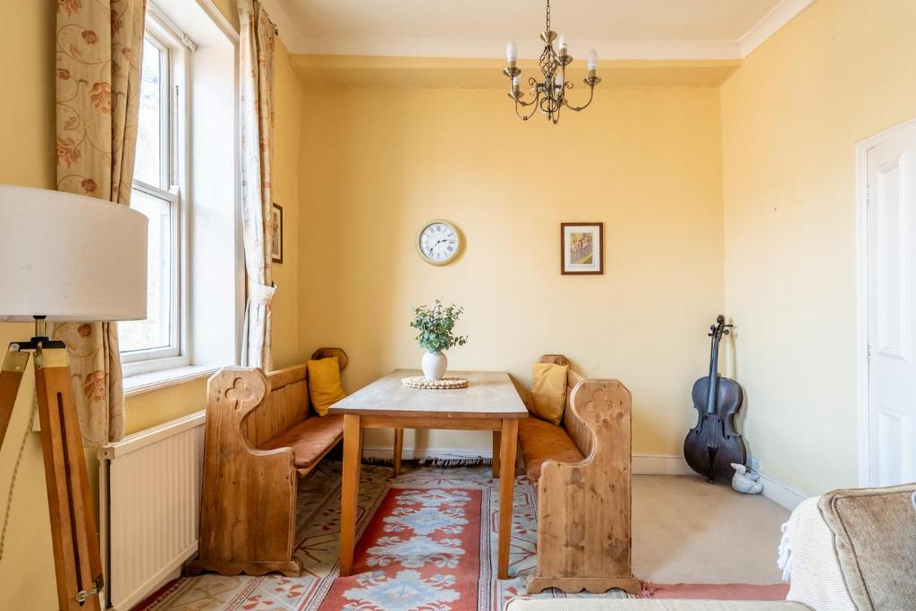 a dining room with a table and chairs and a window at Music House in York