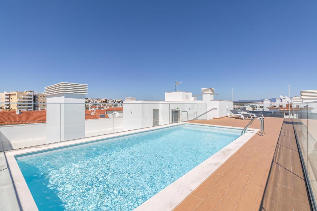 a swimming pool on the roof of a building at Don Tenorio Chic Apartment in Lagos