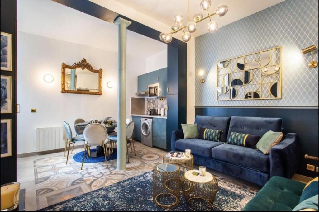 un salon avec un canapé bleu et une table dans l'établissement Charming 2BR # Grands Boulevards, à Paris