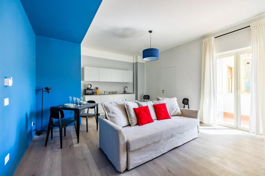 a blue and white living room with a couch and a table at Street Stritt'60 by Wonderful Italy in Naples