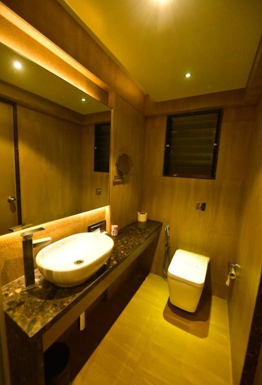 a bathroom with a sink and a toilet at hotel radiant in Mumbai