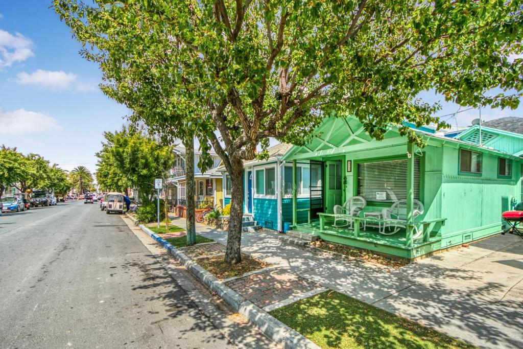 a row of green homes on the side of a street at 322S 322 Sumner Ave in Avalon