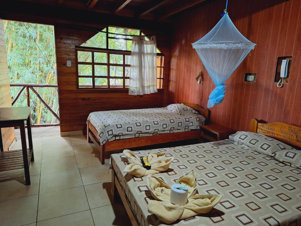 Postel nebo postele na pokoji v ubytování Madera Labrada Lodge Ecologico